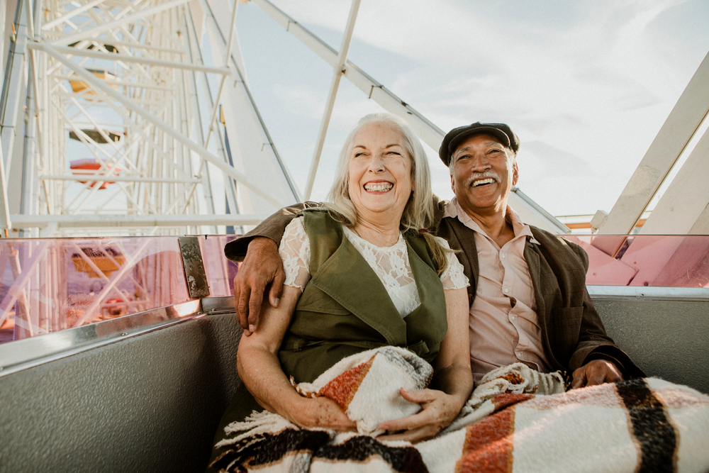 Cheerful,Senior,Couple,Enjoying,A,Ferris,Wheel,By,The,Santa